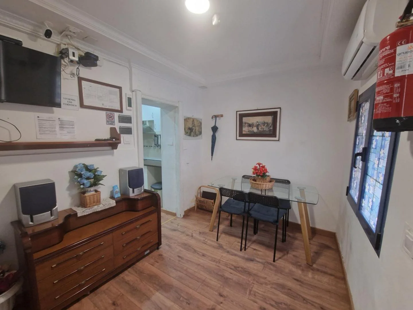 Zona de estar con cómoda, televisión y mesa